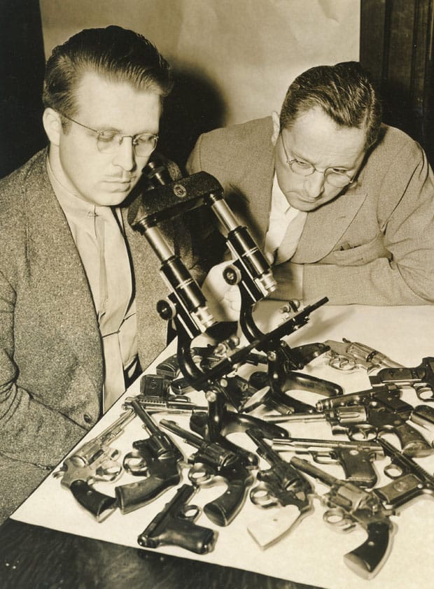 Goddard looks through microscope
